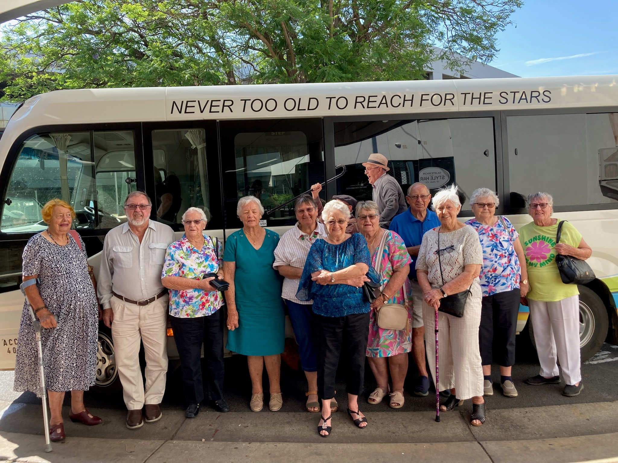 Community Care clients standing in front of the bus